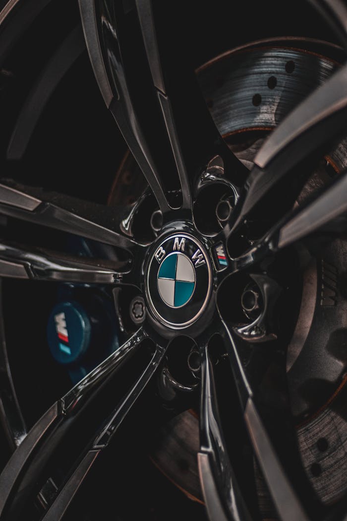 Detailed close-up of a BMW car wheel rim showcasing the iconic logo and sleek design.